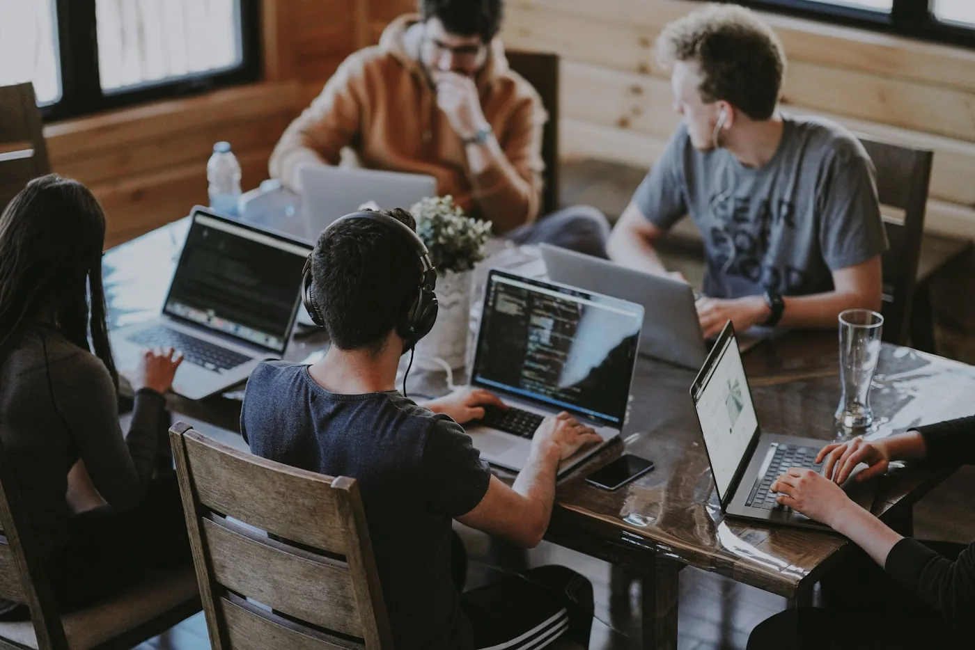 Global team collaborating around shared workspace